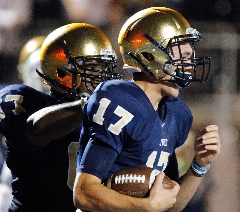 Jesuit quarterback Jacob Palisch (17) had his helmet jostled while scoring a two point...