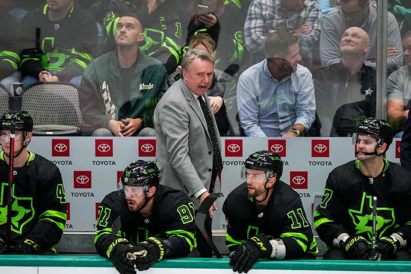 Dallas Stars coach Rick Bowness looks on from the bench during the third period of an NHL...