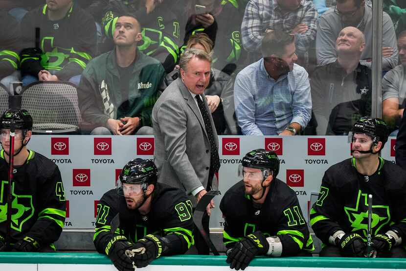 Dallas Stars coach Rick Bowness looks on from the bench during the third period of an NHL...