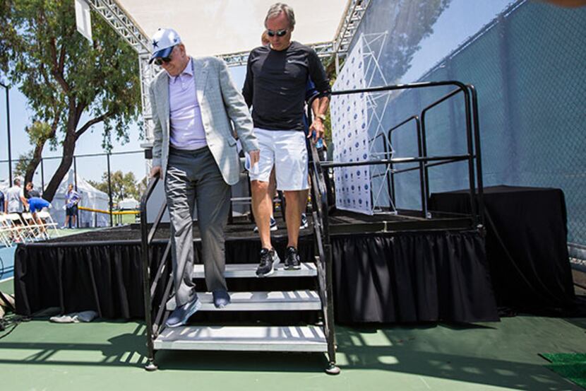 Cowboys owner Jerry Jones exits the stage with Rich Dalrymple, the vice president of public...
