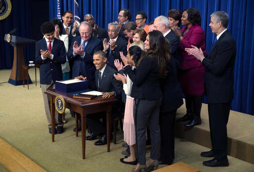 Members of Congress and guests applauded after President Barack Obama signed the Every...