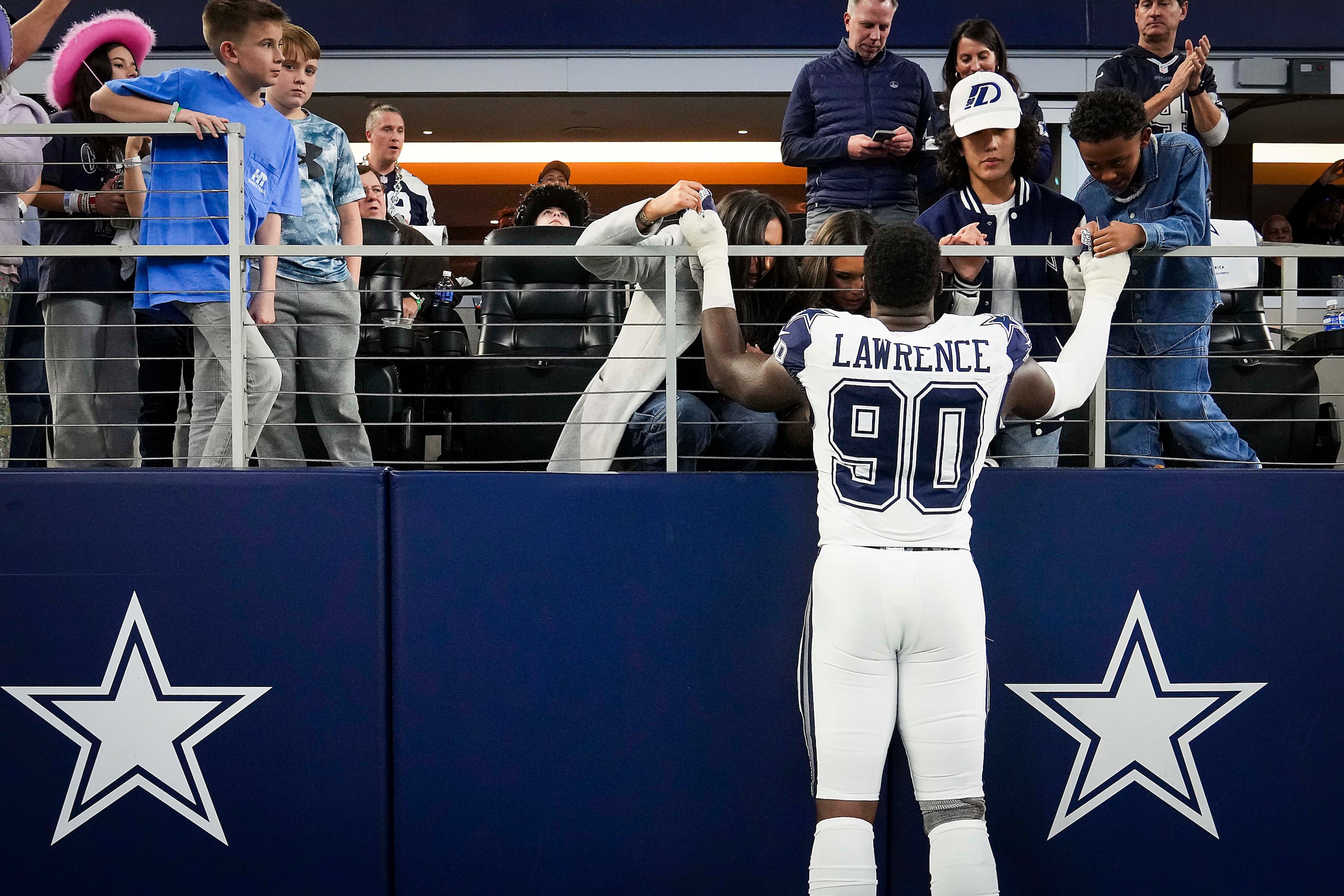 Dallas Cowboys defensive end DeMarcus Lawrence (90) prays with his family before an NFL...