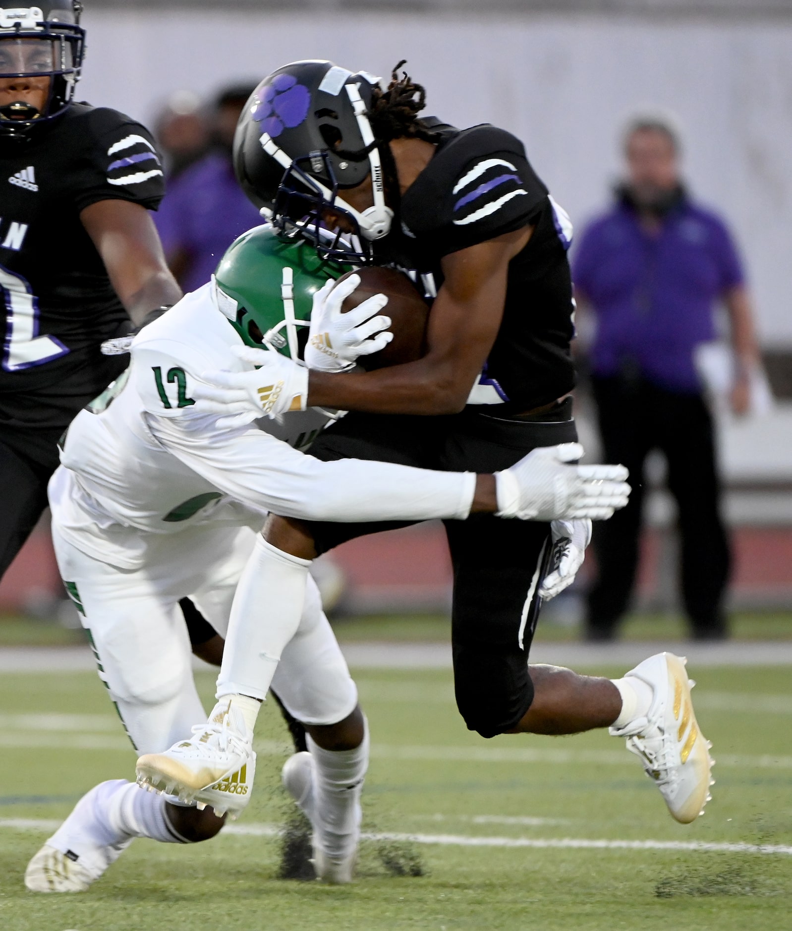 Bryan Adam’s Kenon Jennings (12) tackles Lincoln’s Demetrious Smith (22) in the first half...