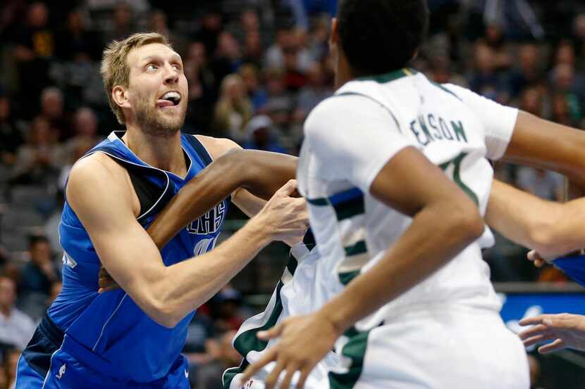 Dallas Mavericks forward Dirk Nowitzki (41) clears a path as he prepares to rebound in a...