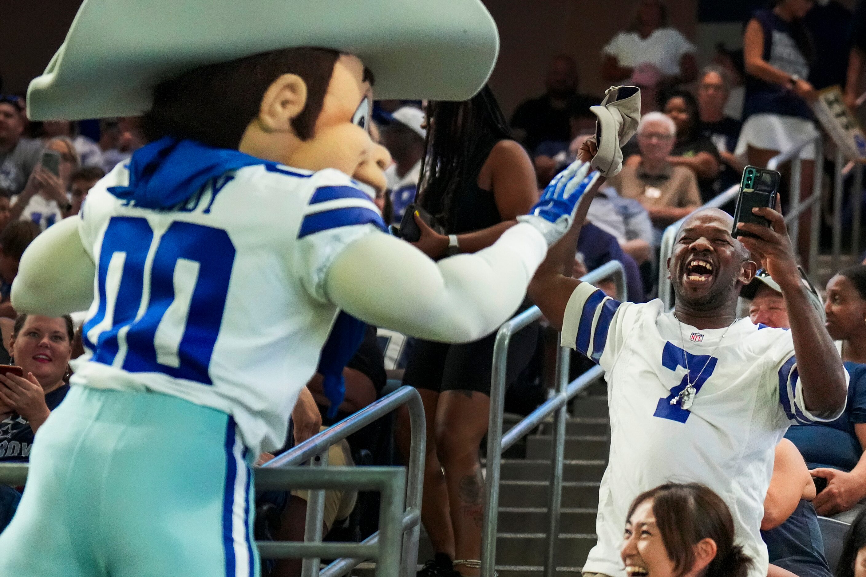 Dallas Cowboys mascot Rowdy high fives fans during the team’s first public training camp...