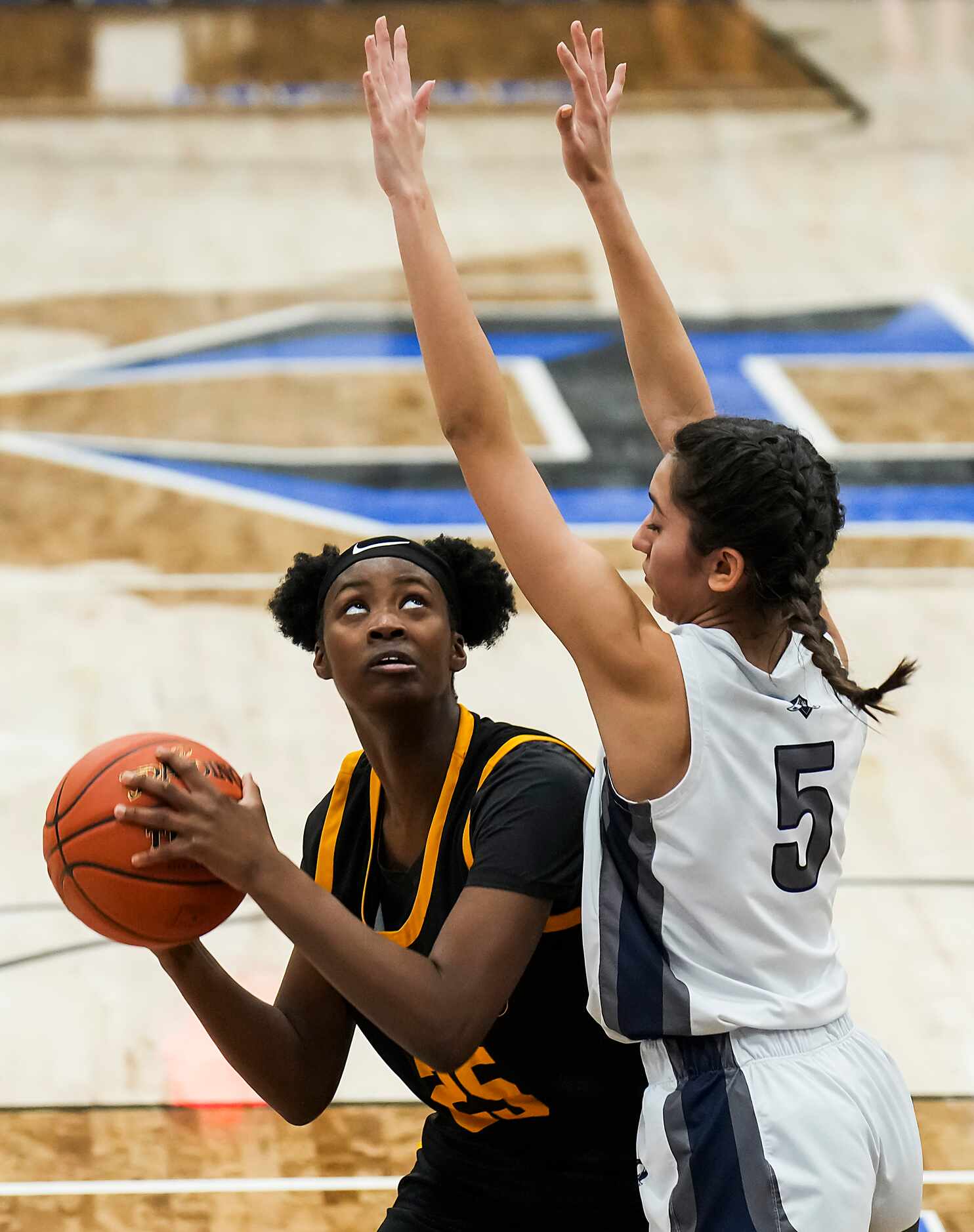 Frisco Memorial's Makayla Vation (25) drives to the basket as Wylie East's Malayla Harold...