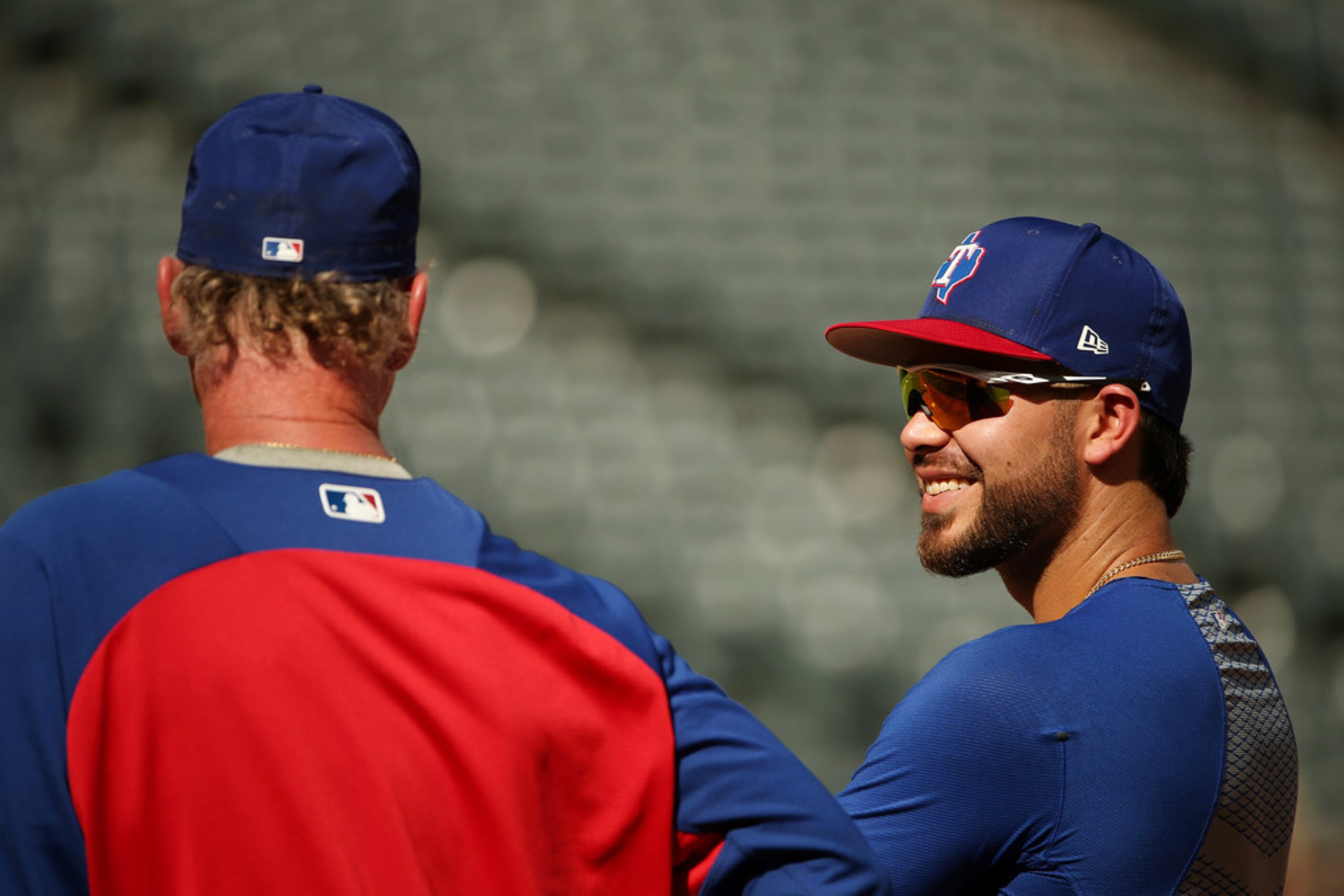 Texas Rangers infielder Renato Nunez (20) talks to first base coach Steve Buechele during...