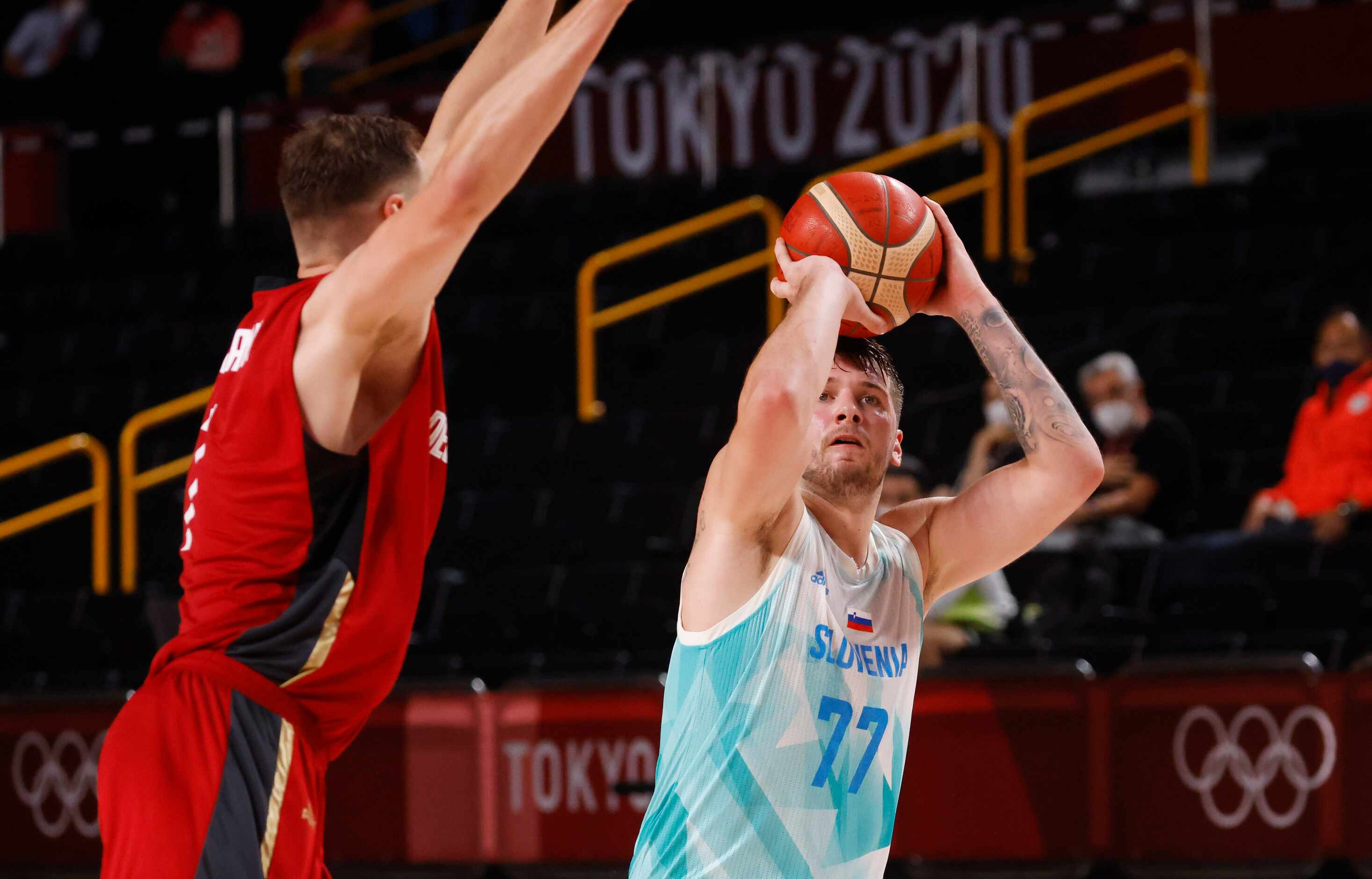 Slovenia’s Luka Doncic (77) shoots over Germany’s Johannes Voigtmann (7) during the second...