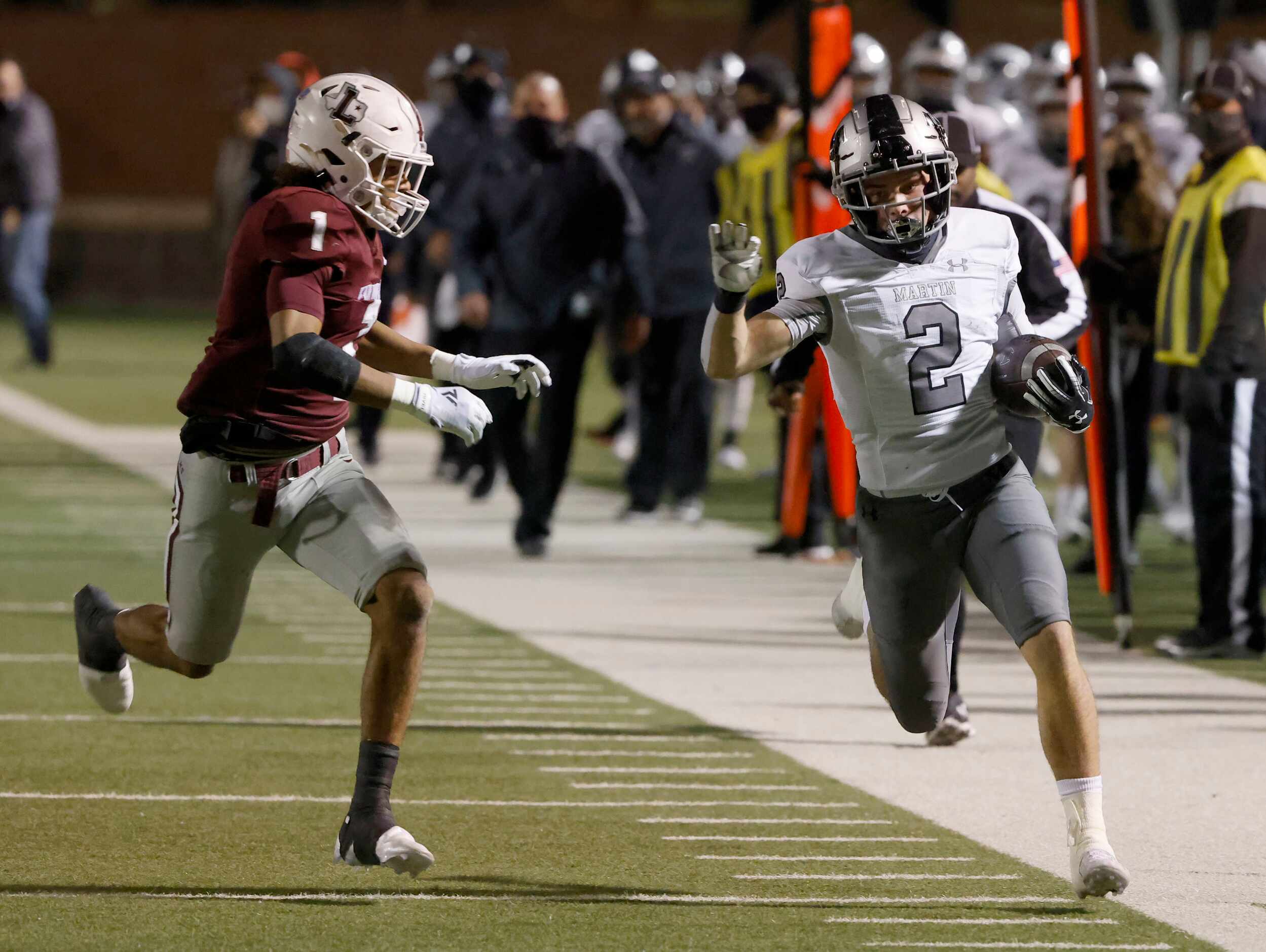 Arlington Martin receiver Cal Robinson (2) tries to get more yardage as he is defended by...