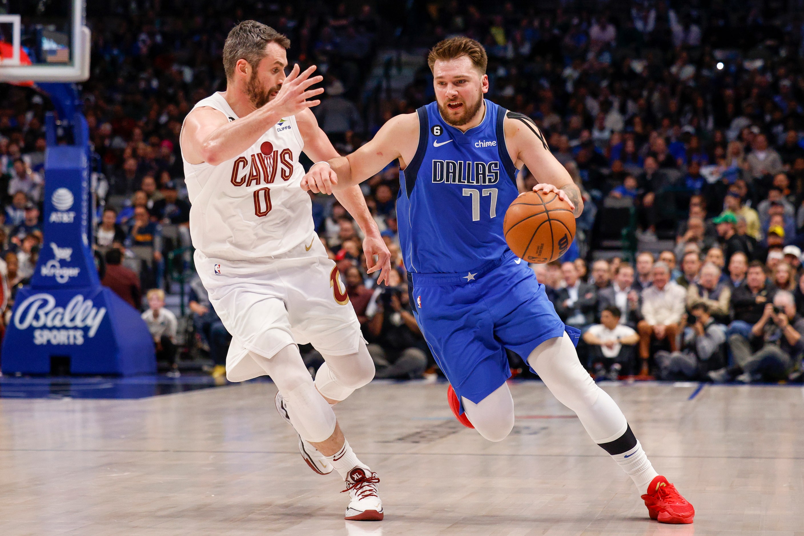 Dallas Mavericks guard Luka Doncic (77) pushes the ball up court alongside Cleveland...