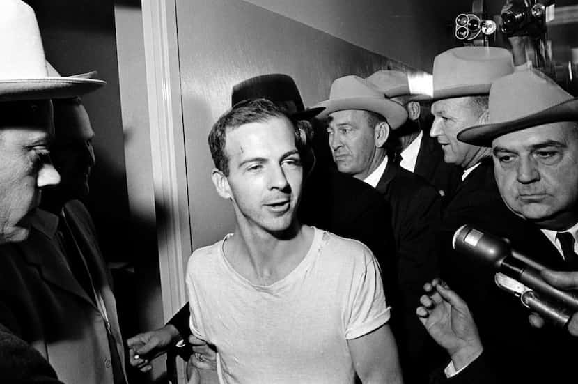  In this Nov. 23, 1963, file photo, surrounded by detectives, Lee Harvey Oswald talks to the...