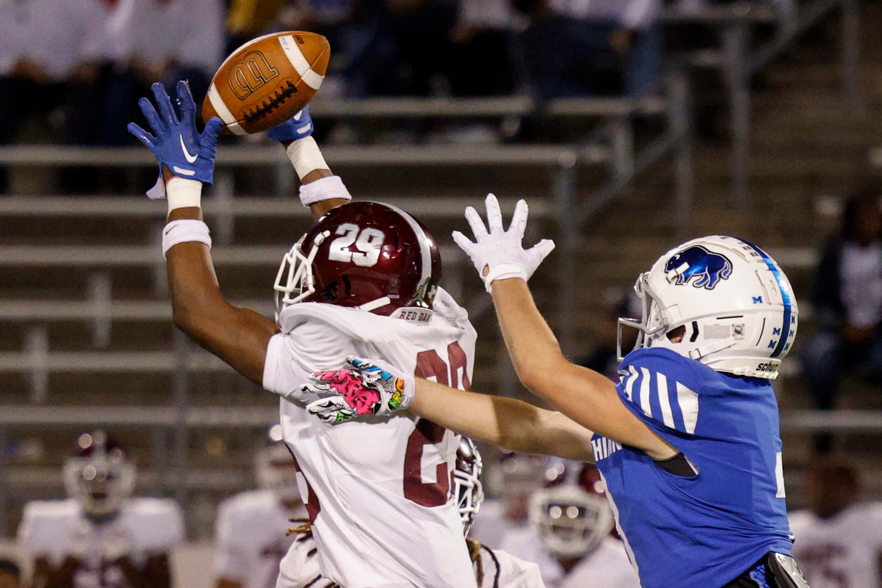 Red Oak defensive back Maurice Wells (29) breaks up a pass intended for Midlothian wide...