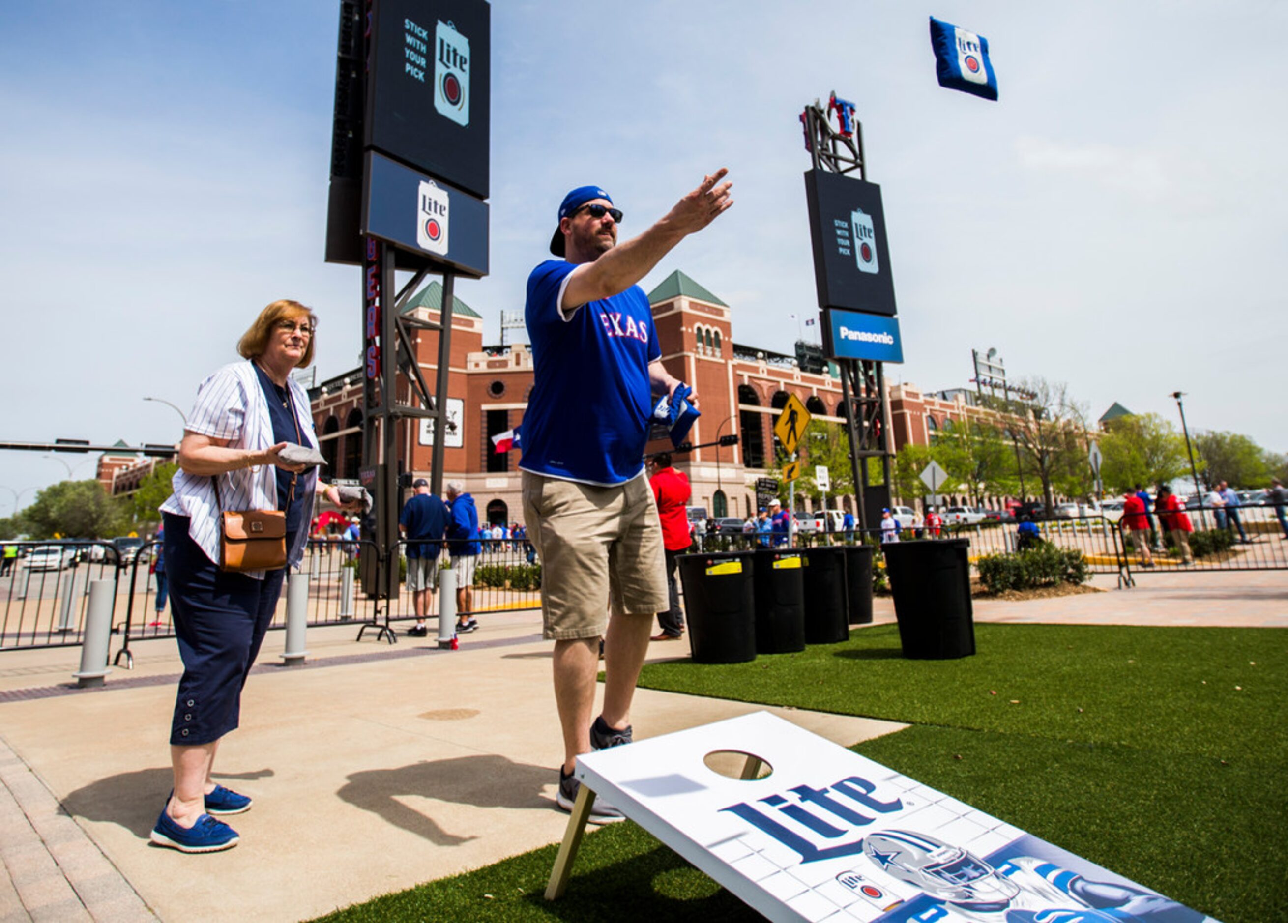 Kathie Clute (left) and Jason Clute play games outside Texas Live! as fans celebrate Texas...