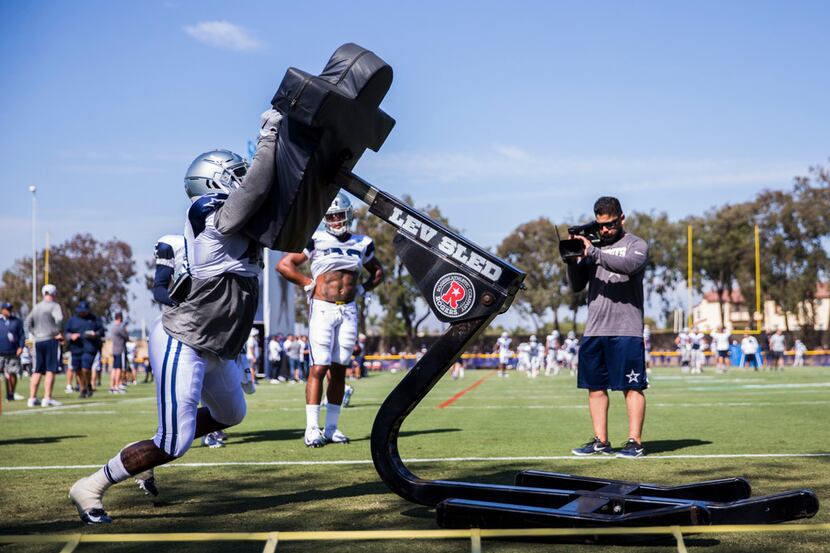 Dallas Cowboys running back Mike Weber (40) takes on the sled during an afternoon practice...
