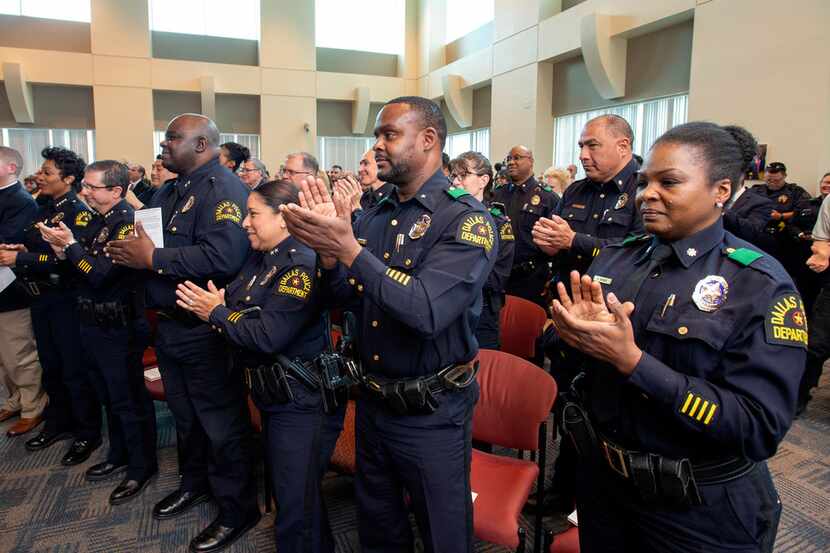 Dallas police officers give a standing ovation as officer Crystal Almeida received the...