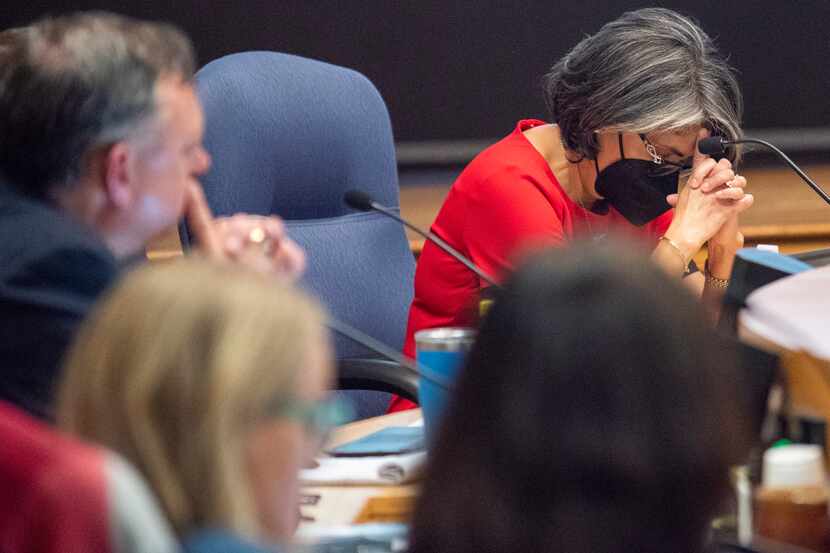Debbie Rentería, Richardson ISD board member, lowers her head as she reacts to the...
