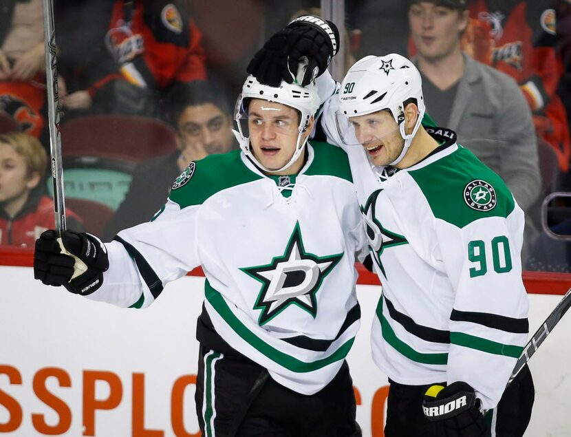 Dallas Stars' Mattias Janmark, left, of Sweden, celebrates his goal against the Calgary...