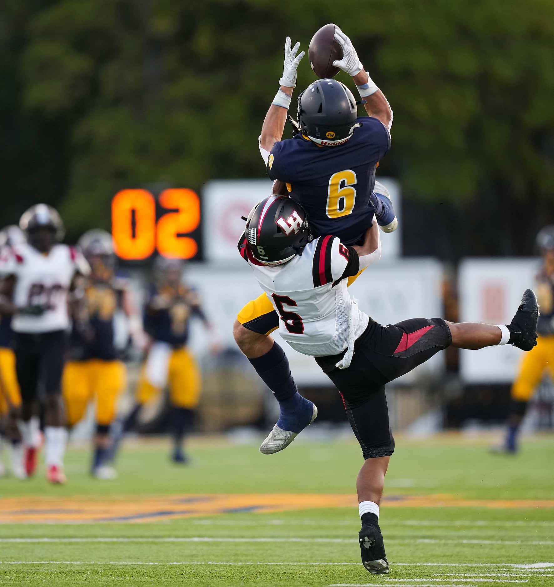 Highland Park wide receiver Luke Herring makes a leaping catch over Lake Highlands’ Cung...