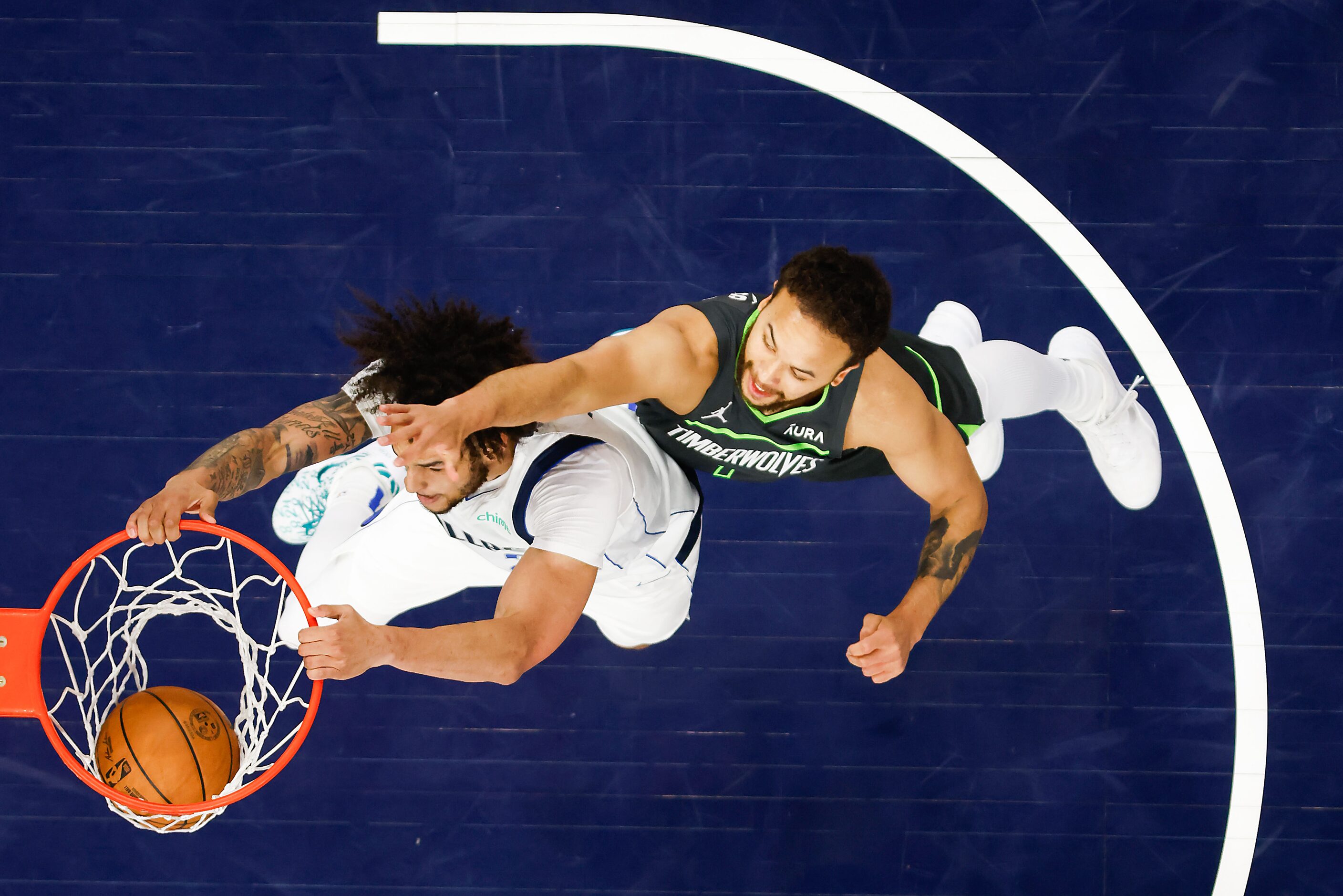 Dallas Mavericks center Dereck Lively II (2) dunks past Minnesota Timberwolves forward Kyle...