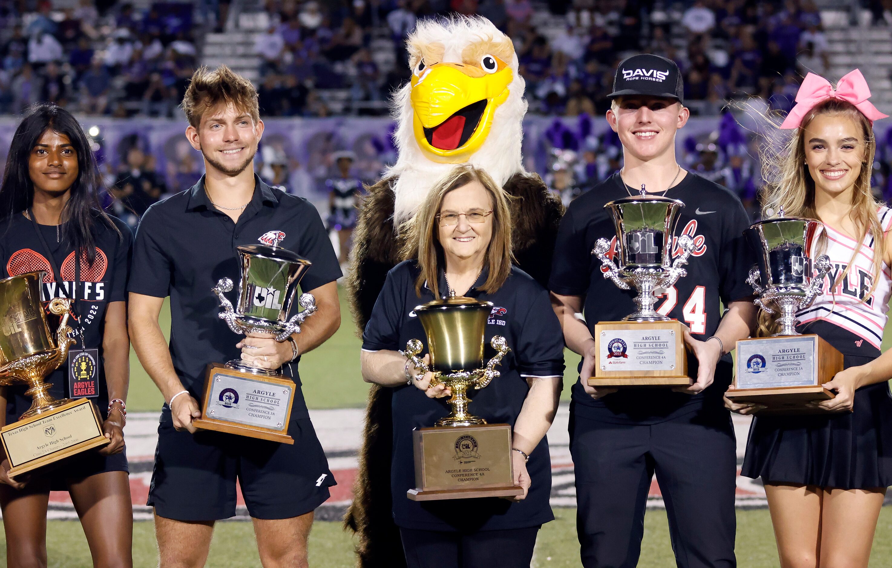 Flanked by students holding individual cups, Argyle superintendent Dr. Telena Wright...