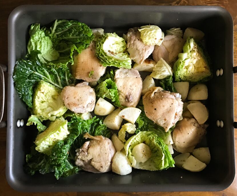 Chicken thighs, savoy cabbage and turnips are partway through roasting: cabbage is added last.