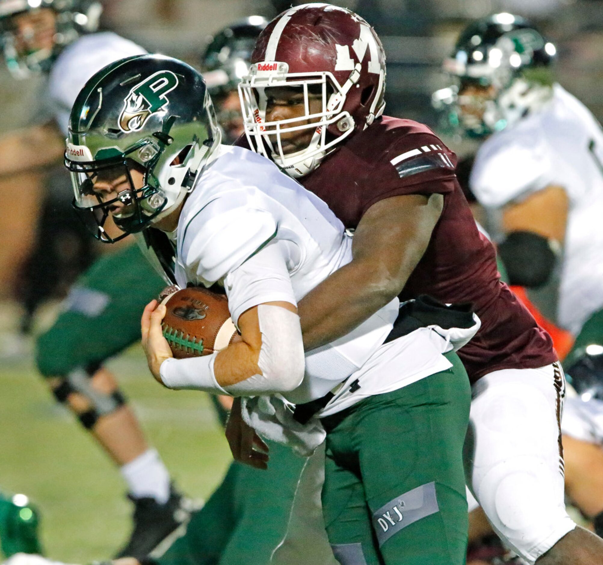 Prosper High School quarterback Jackson Berry (5) is wrapped up by Mesquite High School...