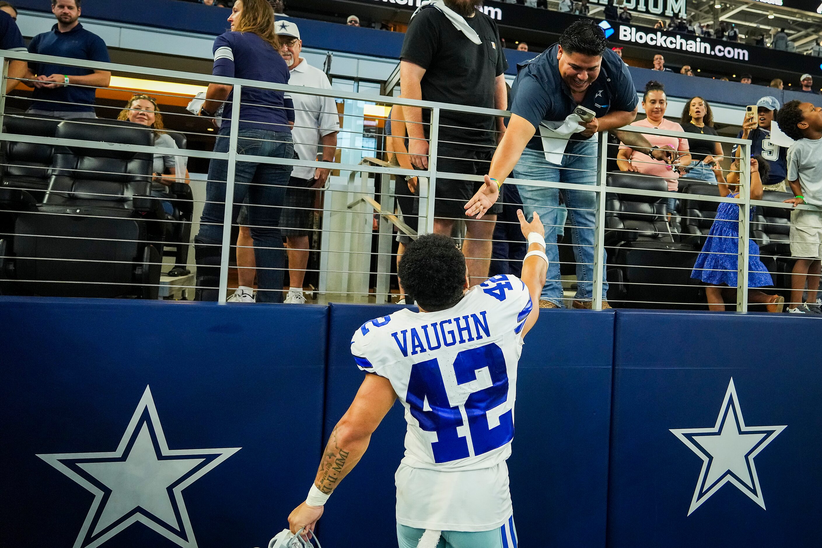 Dallas Cowboys running back Deuce Vaughn celebrates as he leaves the field after an NFL...