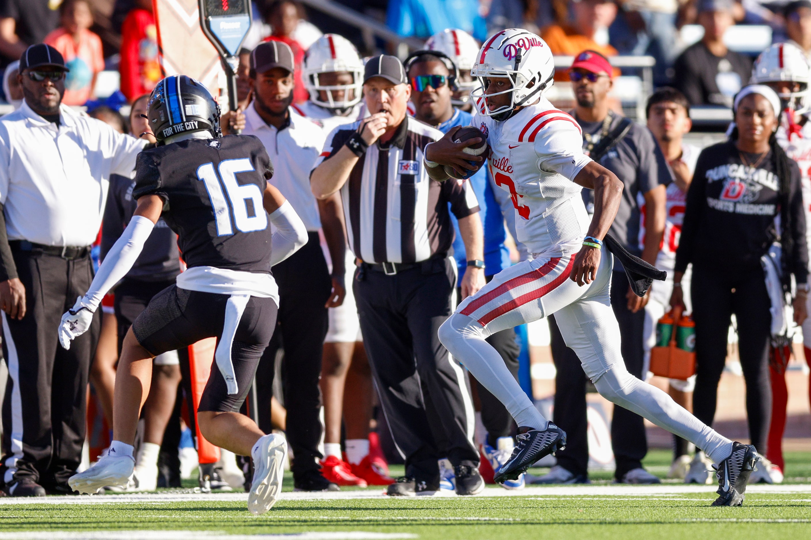 Duncanville quarterback Keelon Russell (12) runs the ball ahead of North Crowley defensive...