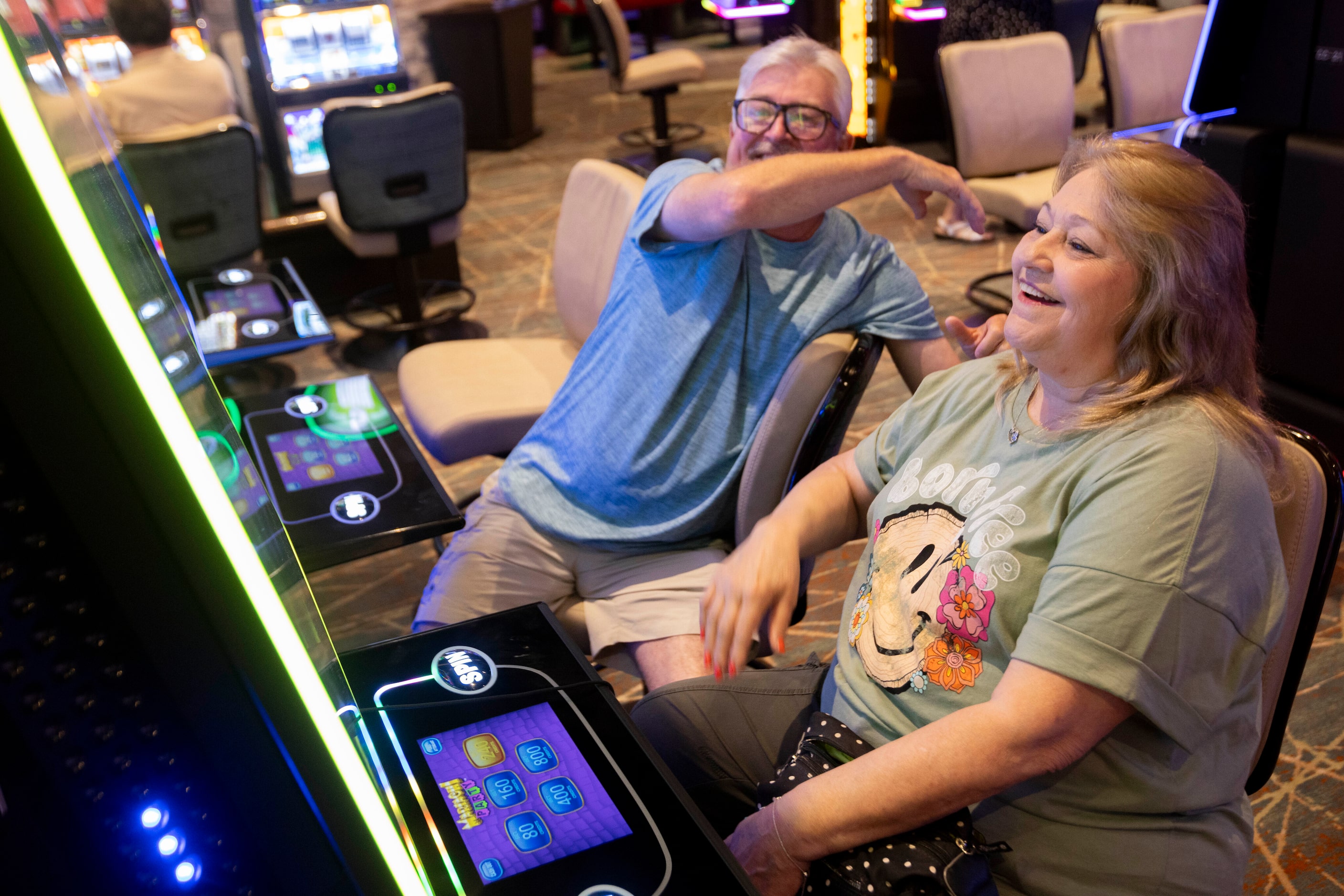 (From left) Tim and Cheryl Baden of Oklahoma react as they get a triple bonus on a slot...