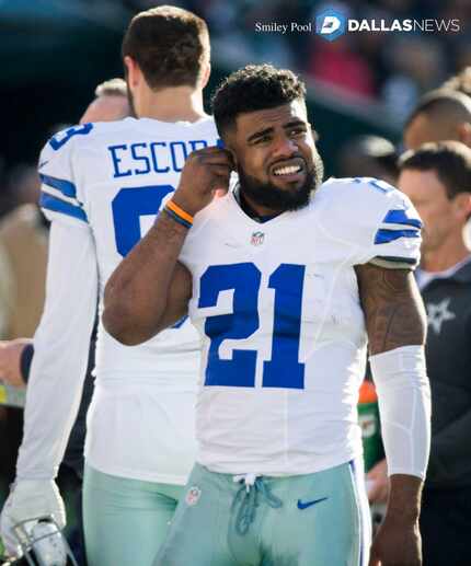 Dallas Cowboys running back Ezekiel Elliott (21) watches from the sidelines during the first...