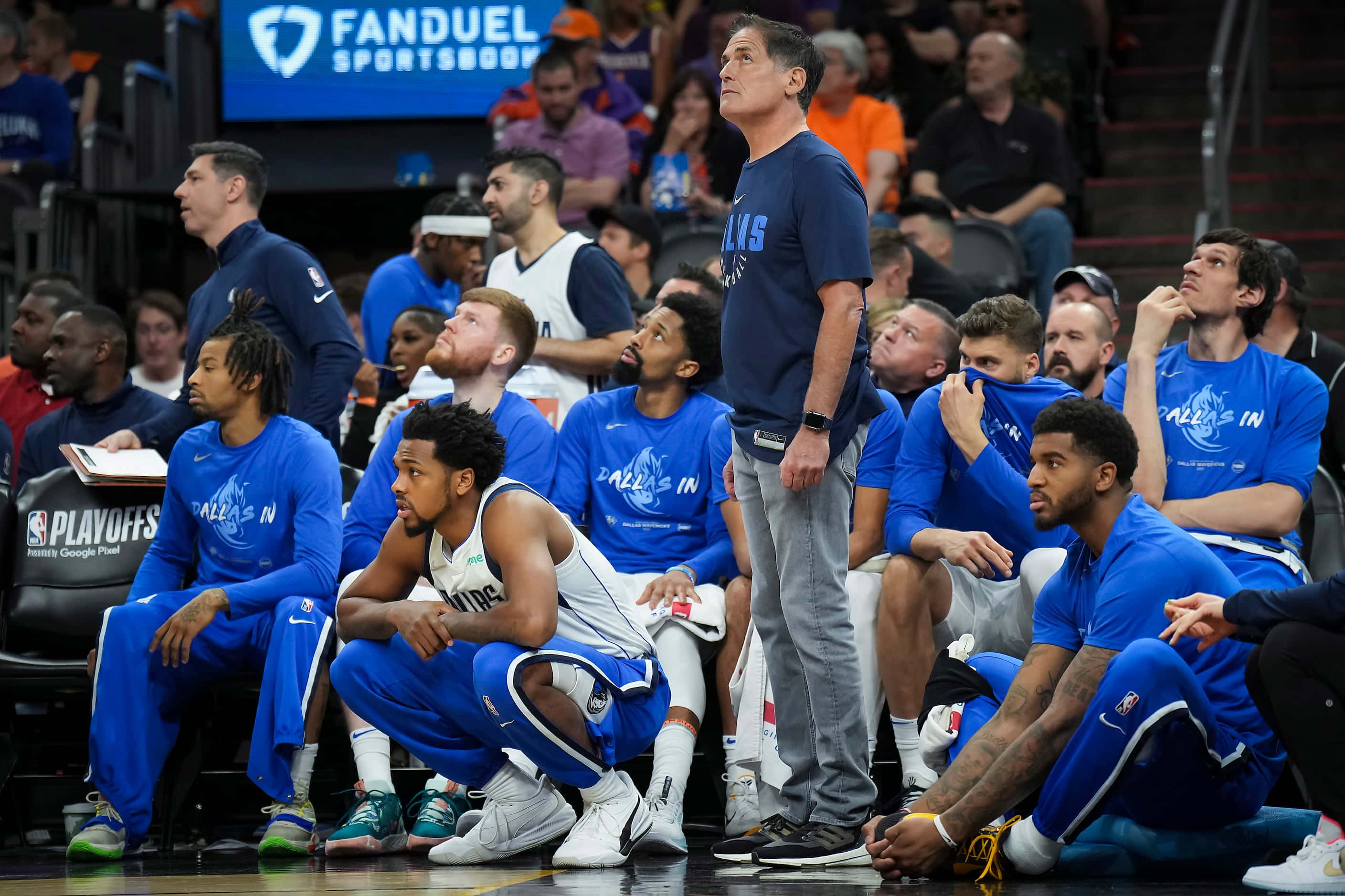 Dallas Mavericks owner Mark Cuban watches from the bench during the third quarter in Game 2...