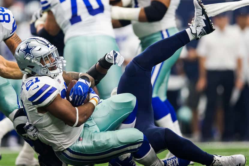 Dallas Cowboys running back Ezekiel Elliott (21) is tackled by Los Angeles Rams nose tackle...