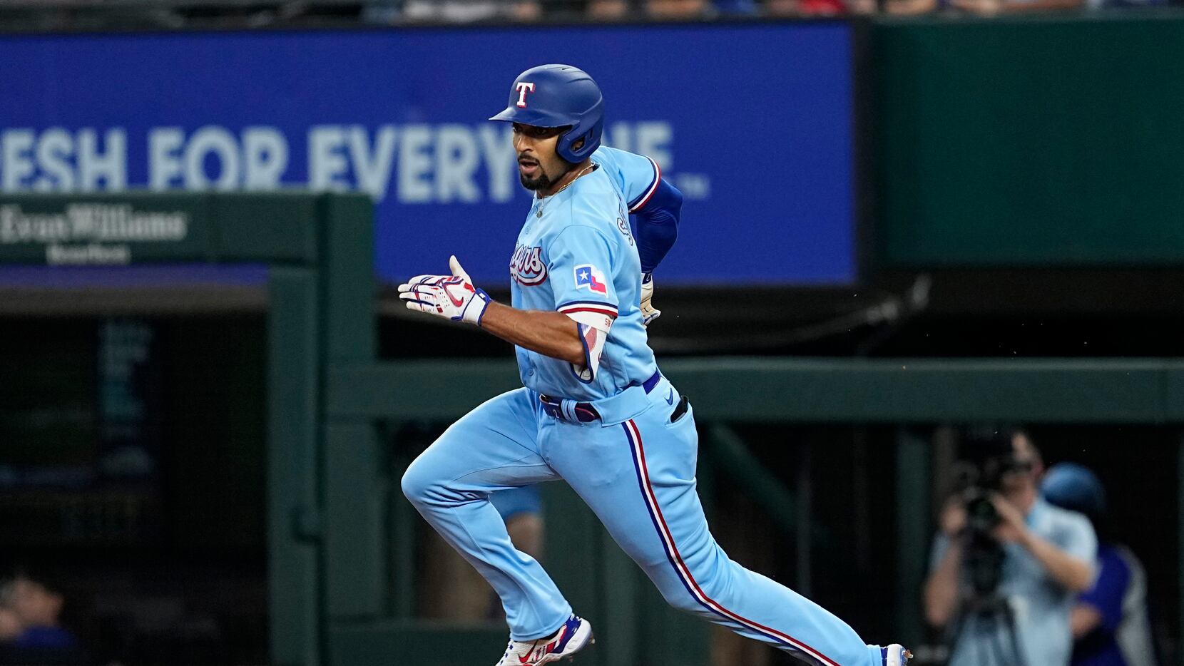 Texas Rangers' Marcus Semien heads to second base after hitting a leadoff double in the...