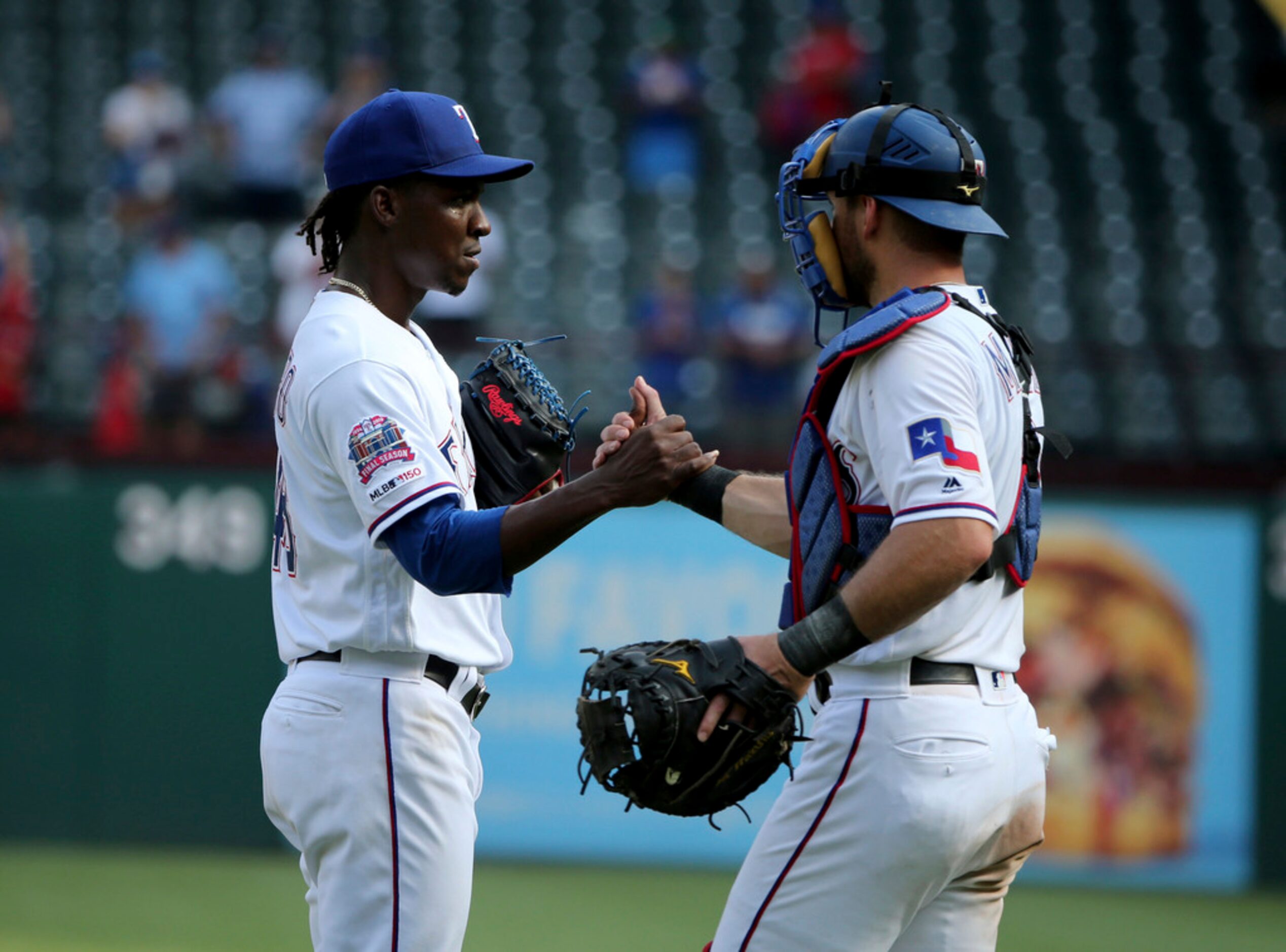 Texas Rangers relief pitcher Rafael Montero, left, is congratulated by catcher Jeff Mathis,...