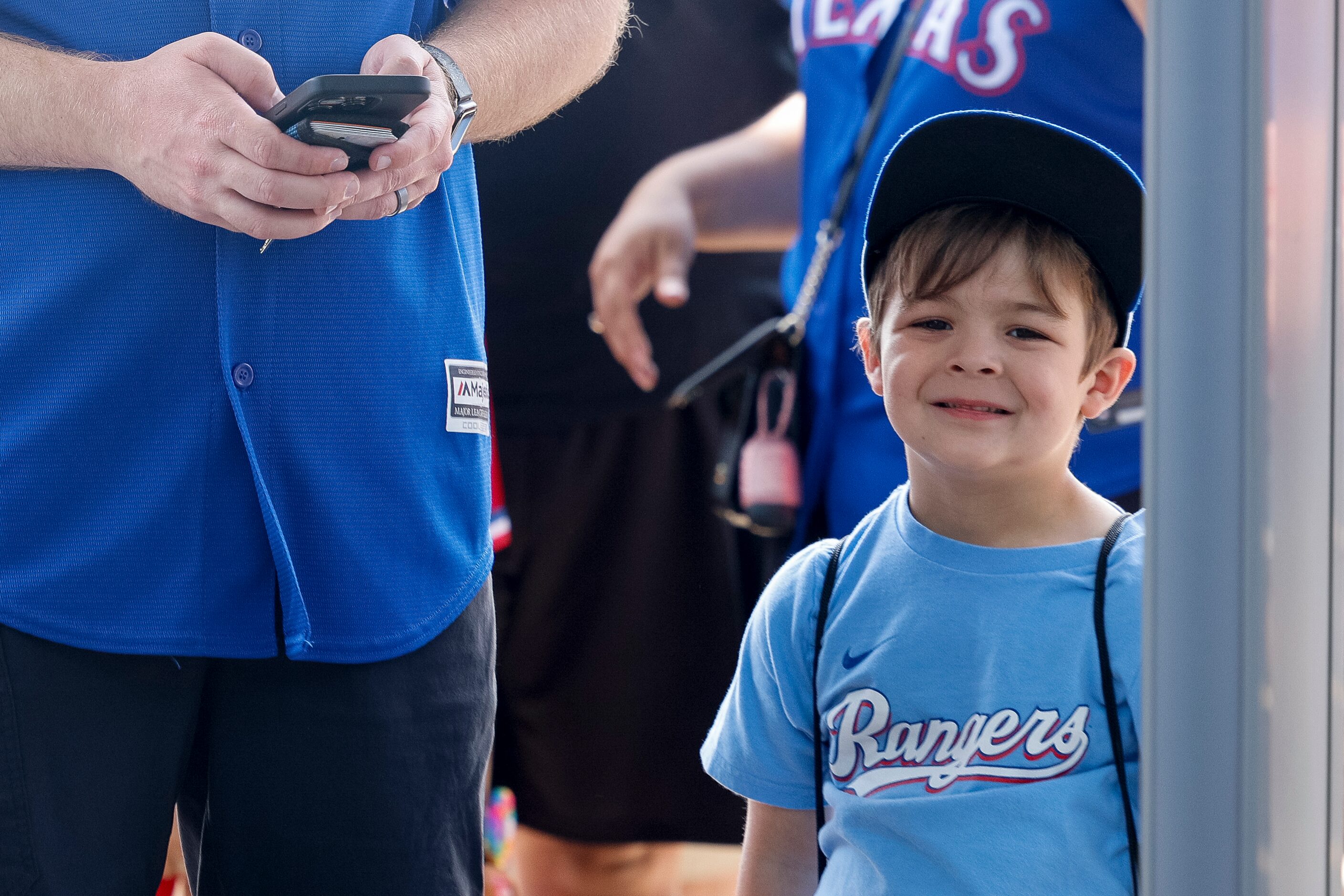 Four-and-a-half year old Kinsler Powers smiles as he waits to enter the ballpark before the...