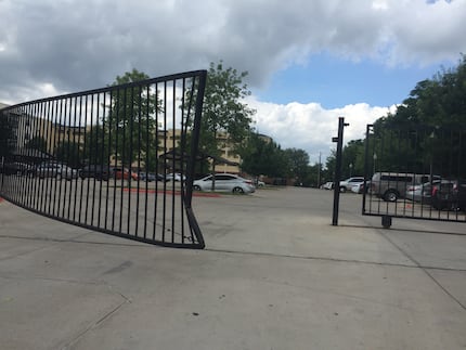 One parking-lot gate at the Midtown Apartments was broken when a resident drove into it, the...