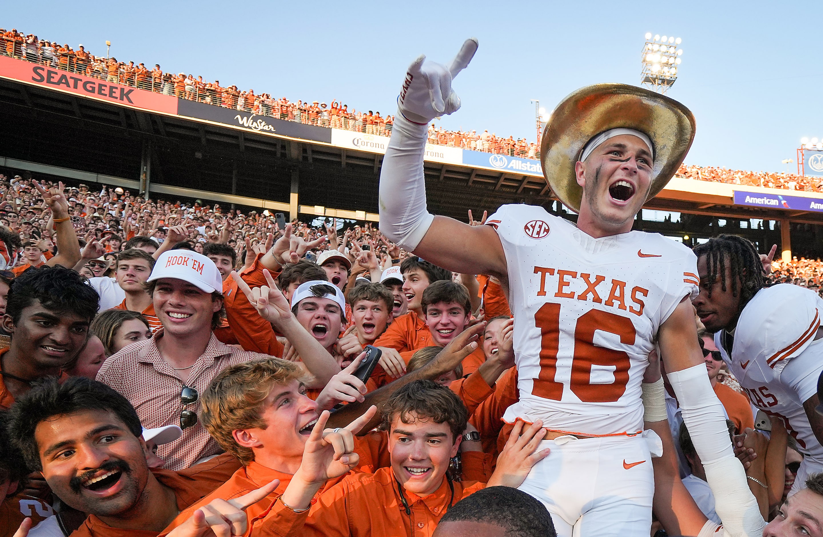 Texas defensive back Michael Taaffe (16) wears the Golden Hat Trophy as he celebrates with...