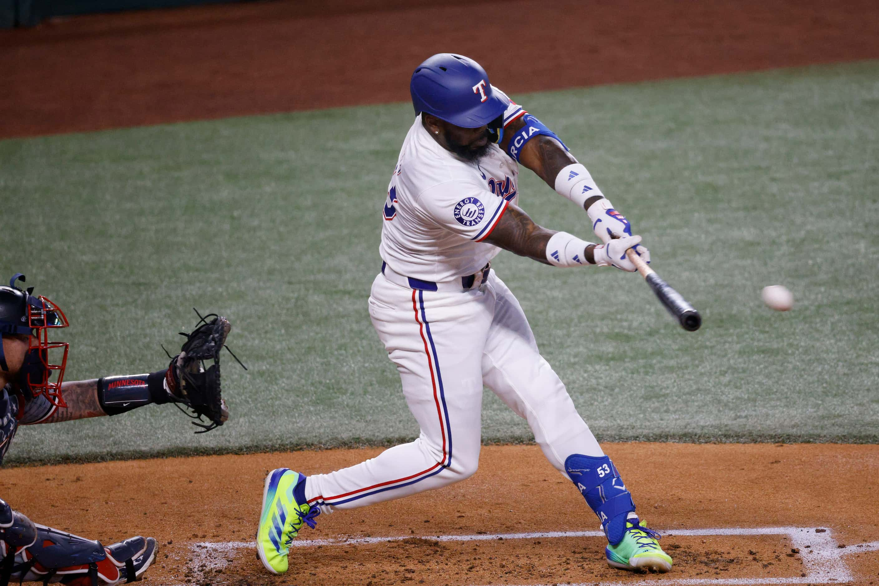 Texas Rangers outfielder Adolis García (53) hits a single during the first inning of a...