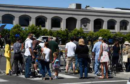 Neighbors and media members gather outside of the Chabad of Poway Synagogue Saturday, April...