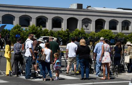 Neighbors and media members gather outside of the Chabad of Poway Synagogue Saturday, April...