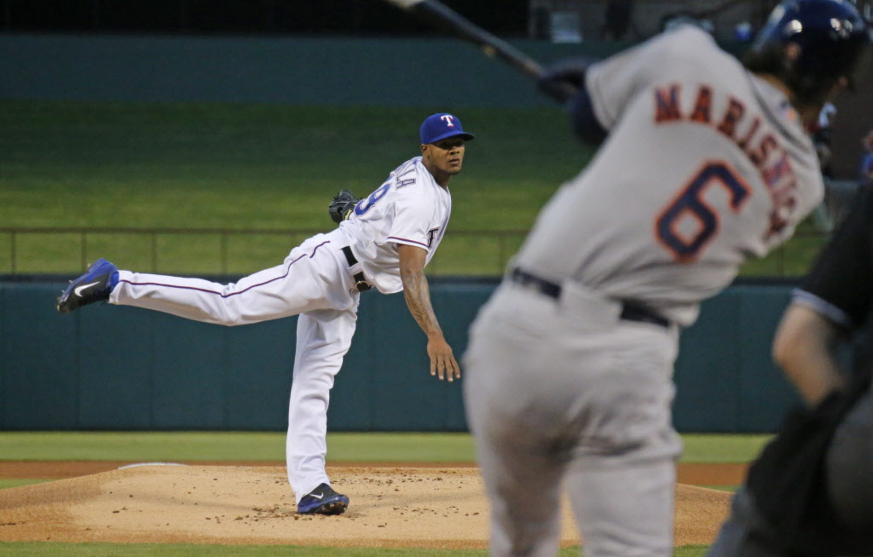 Texas starting pitcher Lisalverto Bonilla throws a first-inning pitch to Houston's Jake...