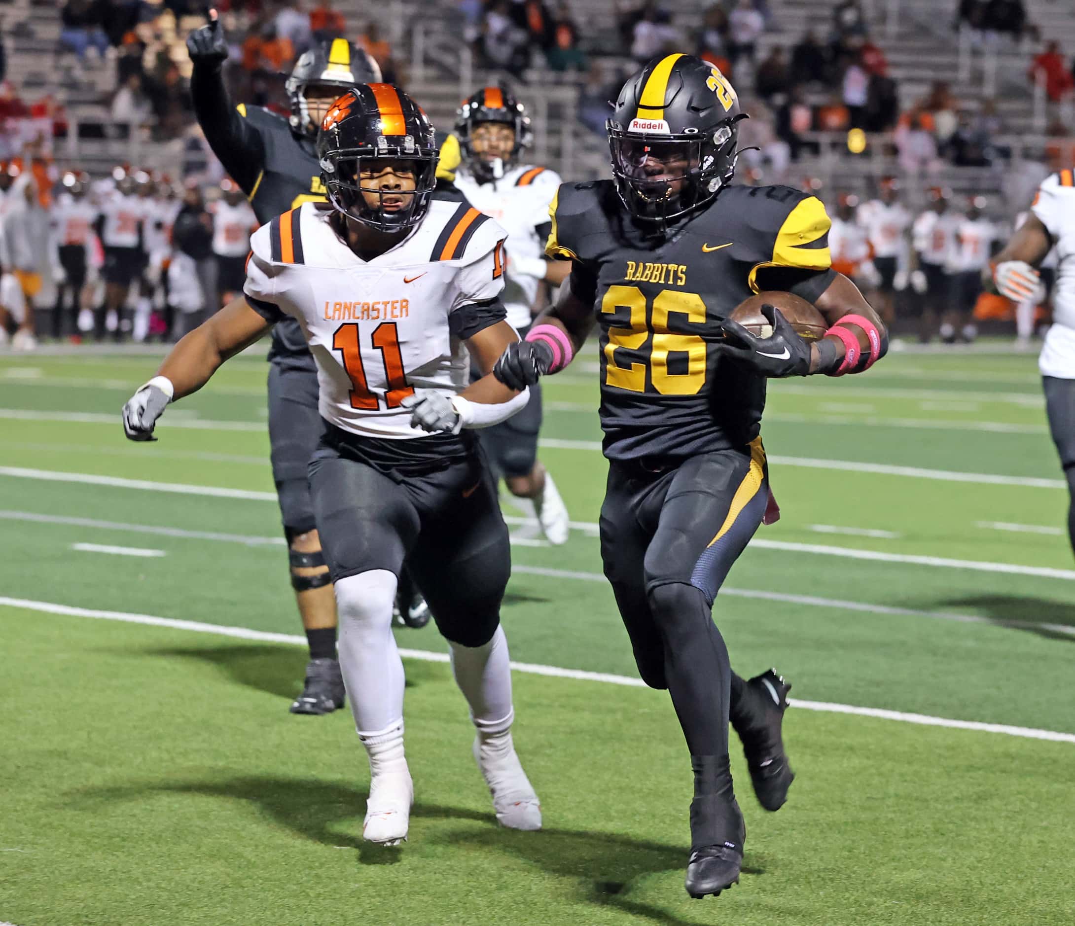 Forney High’s Javian Osborne (26) gats past Lancaster high’s DaVon Berry (11) and heads to...