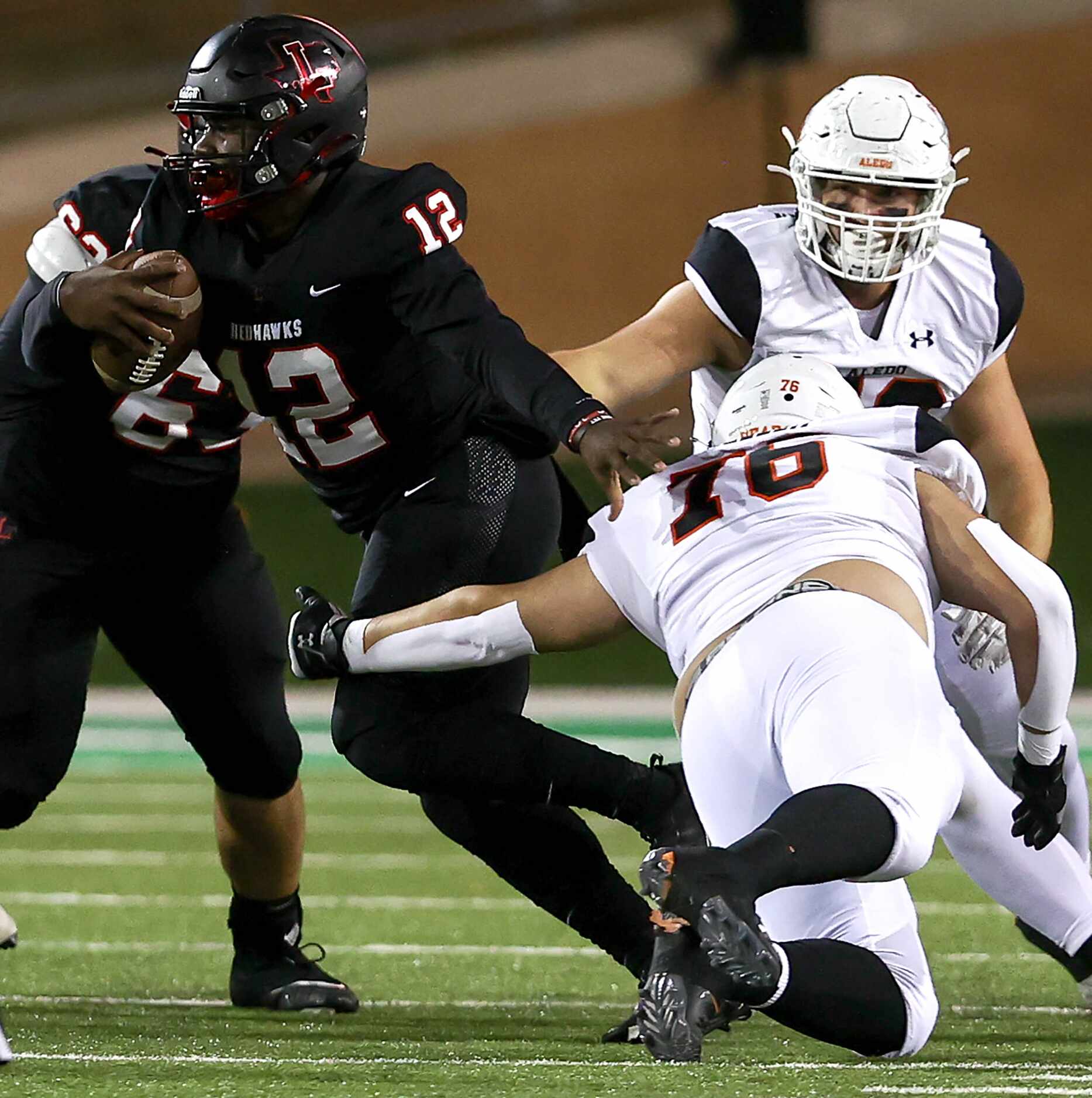 Frisco Liberty quarterback Keldric Luster (12) tries to break a tackle against Aledo...