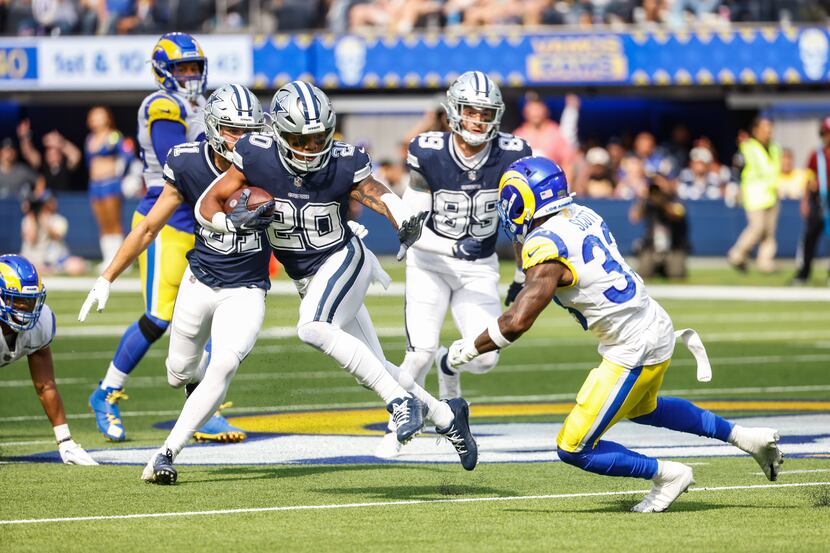 Dallas Cowboys running back Tony Pollard (20) gets past Los Angeles Rams safety Nick Scott...