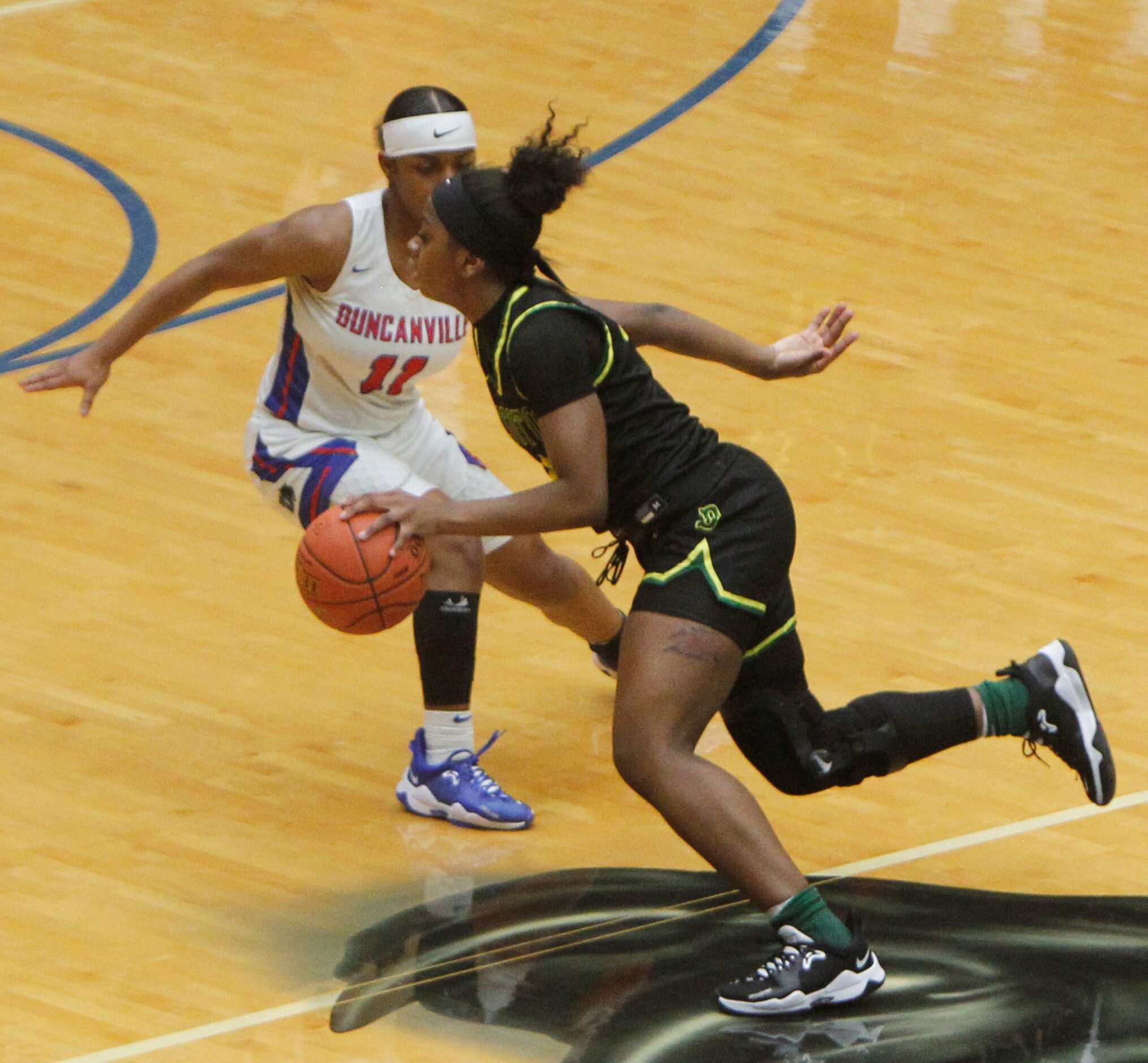 DeSoto's Ja'Mia Harris (4) dribbles around the defense of Duncanville's Tristen Taylor (11)...