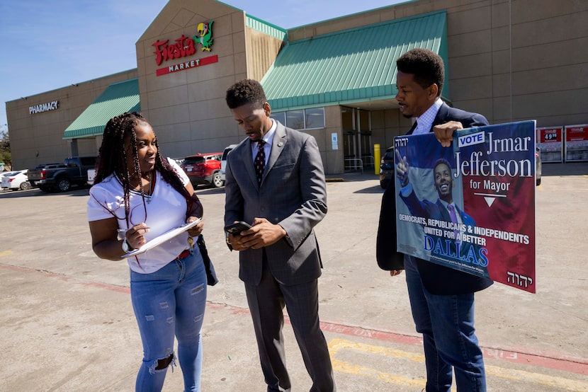 Jrmar Jefferson (center), a potential Dallas mayoral candidate, chats with Courtney Tuner as...