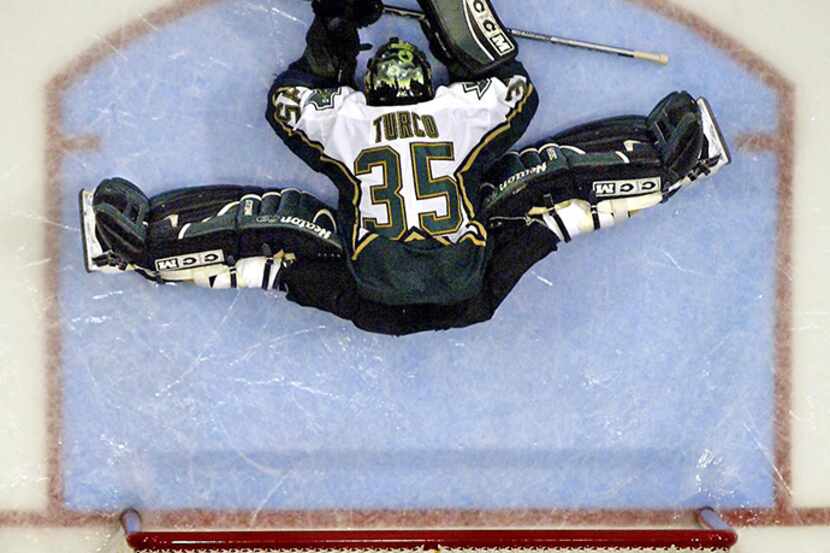  December 29, 2002--Dallas Stars goalie Marty Turco stretches before the start of the second...