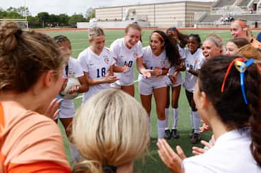 Wakeland High players cheer in a huddle following their win against Frisco Reddy High in...