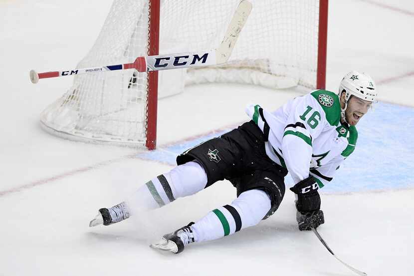 Dallas Stars center Jason Dickinson (16) celebrates his game-winning goal as he falls to the...