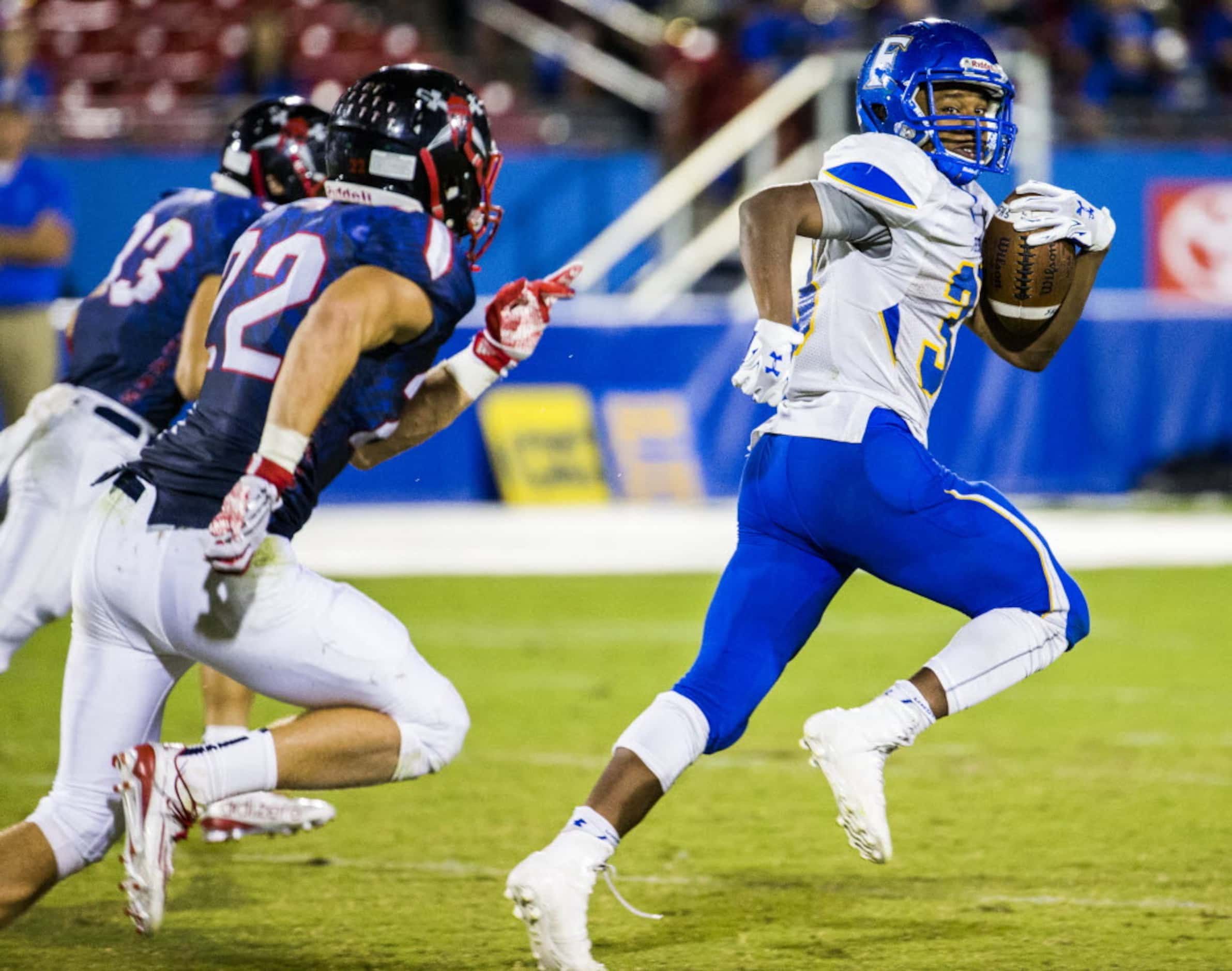 Frisco fullback Idrees Ali (33) looks back as he breaks away from Frisco Centennial...